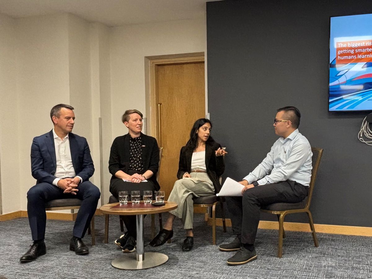 The four panellists seated in front of the screen