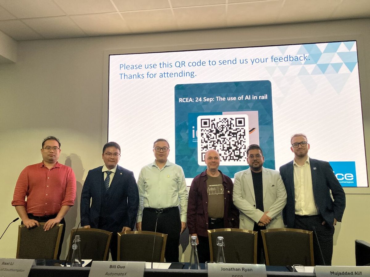 The speakers and hosts standing in front of the feedback slide