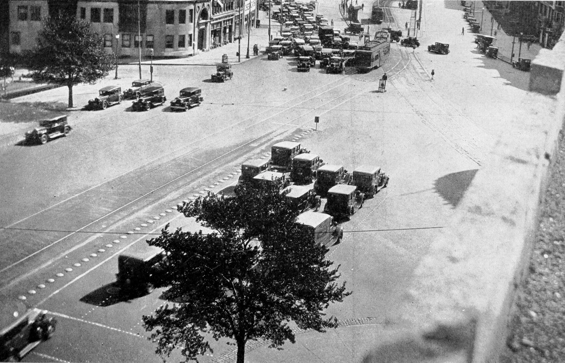Motor cars and a streetcar in a busy American street, late 1920s